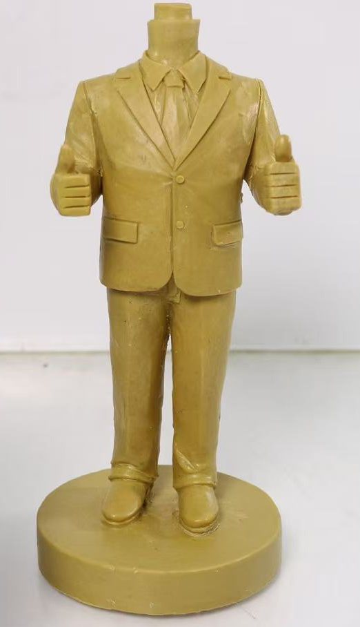 Hand-sculpted clay body prototype of a custom executive retirement bobblehead in a business suit with a thumbs-up pose.
