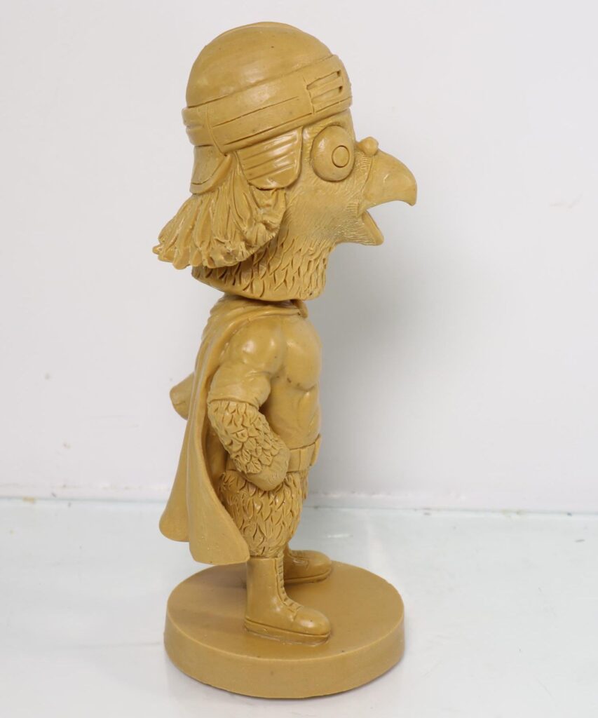 Hand-sculpted master model of a custom pigeon mascot bobblehead, front view